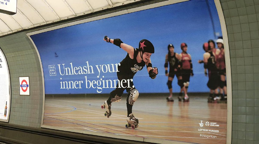 This Girl Can campaign ad poster in a London underground station featuring girl on roller skates with the text 