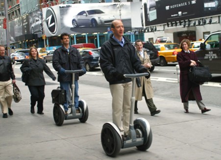 Image of men riding segways on the pavement