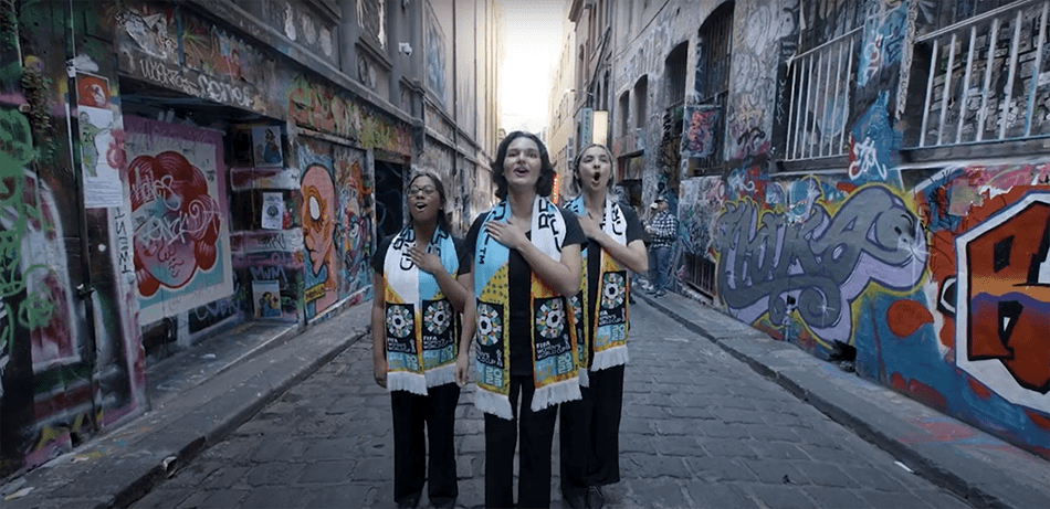 Three women singing in a street